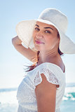 Pretty brunette wearing sunhat and looking at camera