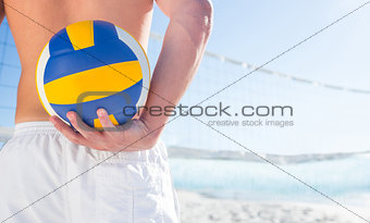 Handsome man holding volleyball