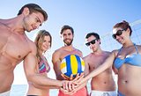 Group of friends holding volleyball