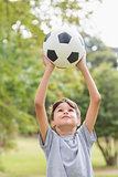 Boy holding a soccer ball in the park