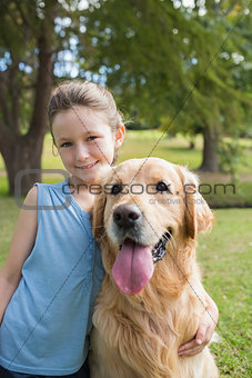 Little girl with her dog in the park
