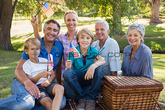Happy family in the park and holding american flag
