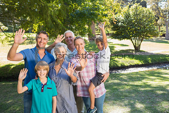 Happy family waving at camera