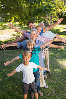 Happy family with arms outstretched in the park