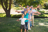 Happy family with arms outstretched in the park
