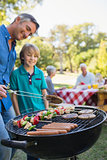 Happy father doing barbecue with his son