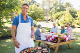 Happy man doing barbecue for his family