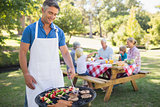 Happy man doing barbecue for his family