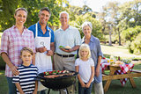 Happy family doing barbecue in the park