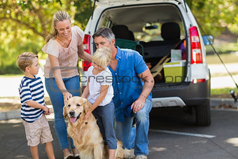 Happy family with their dog in the park