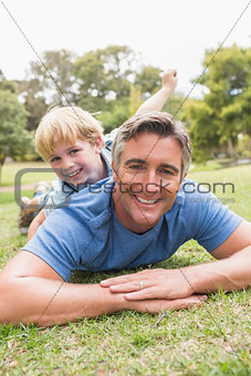 Happy father and his son smiling at camera