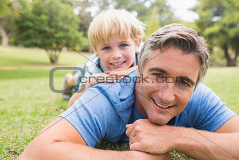 Happy father and his son smiling at camera