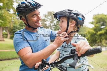 Happy father on a bike with his son