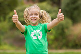 Happy little girl in green with thumbs up