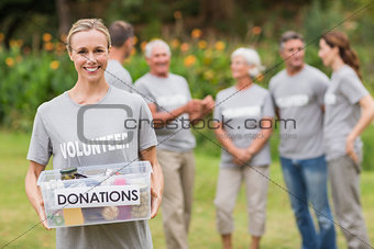 Happy volunteer holding donation box