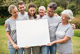 Happy volunteer family holding a blank