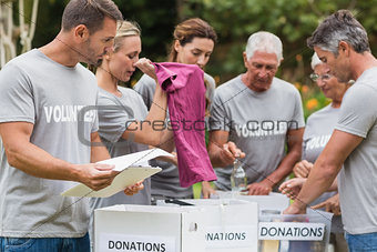 Happy volunteer looking at donation box