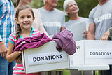 Happy volunteer family holding donation boxes