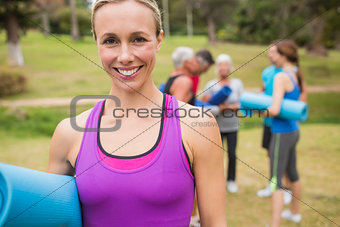 Happy athletic group holding mat