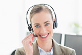 Smiling businesswoman with headset looking at camera