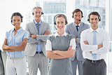 Business people with headsets smiling at camera