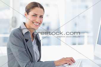 Smiling businesswoman using computer