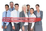 Smiling business people surrounding by red strip