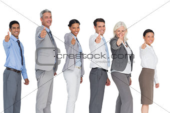 Happy business people looking at camera with thumbs up
