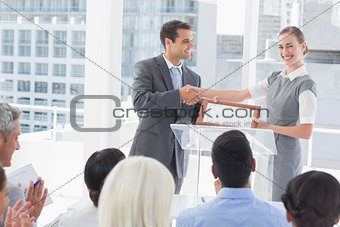 Business people receiving award