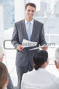 Happy businessman looking at camera during meeting