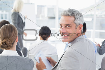 Businessman looking at camera during meeting