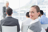 Businesswoman looking at camera during meeting