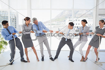 Business people pulling rope