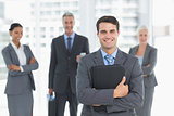 Businessman with colleagues behind in office