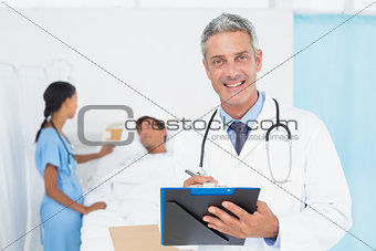 Doctor with colleagues and patient behind