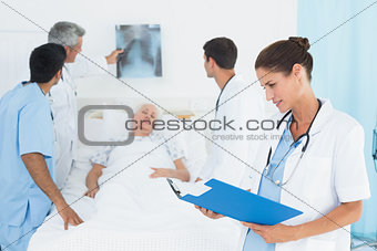 Report reading with colleagues and patient behind