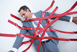 Businessman trapped by red tape