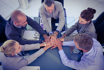 Business team putting their hands together
