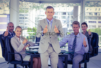 Business team showing thumbs up