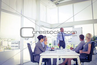 Businessman giving presentation to his colleagues