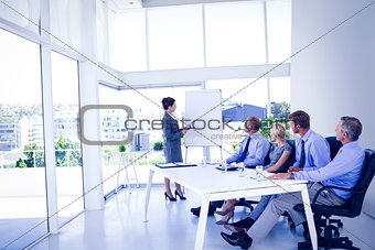 Businesswoman giving presentation to colleagues