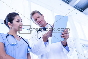 Nurse and doctor looking at tablet pc