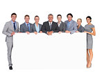 Smiling business team holding poster