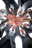 Smiling business team standing in circle hands together