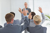 Business team raising hands during conference