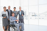 Disabled businessman with his colleagues smiling at camera