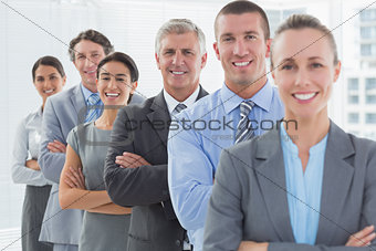 Smiling business team standing in a line