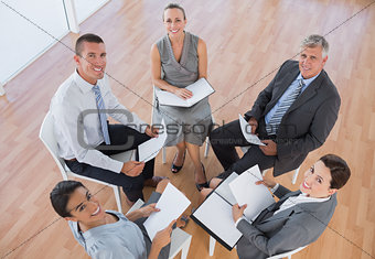 Business team sitting in circle and discussing