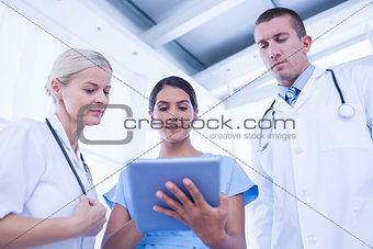 Doctors looking together at tablet