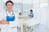 Smiling doctor holding patients file